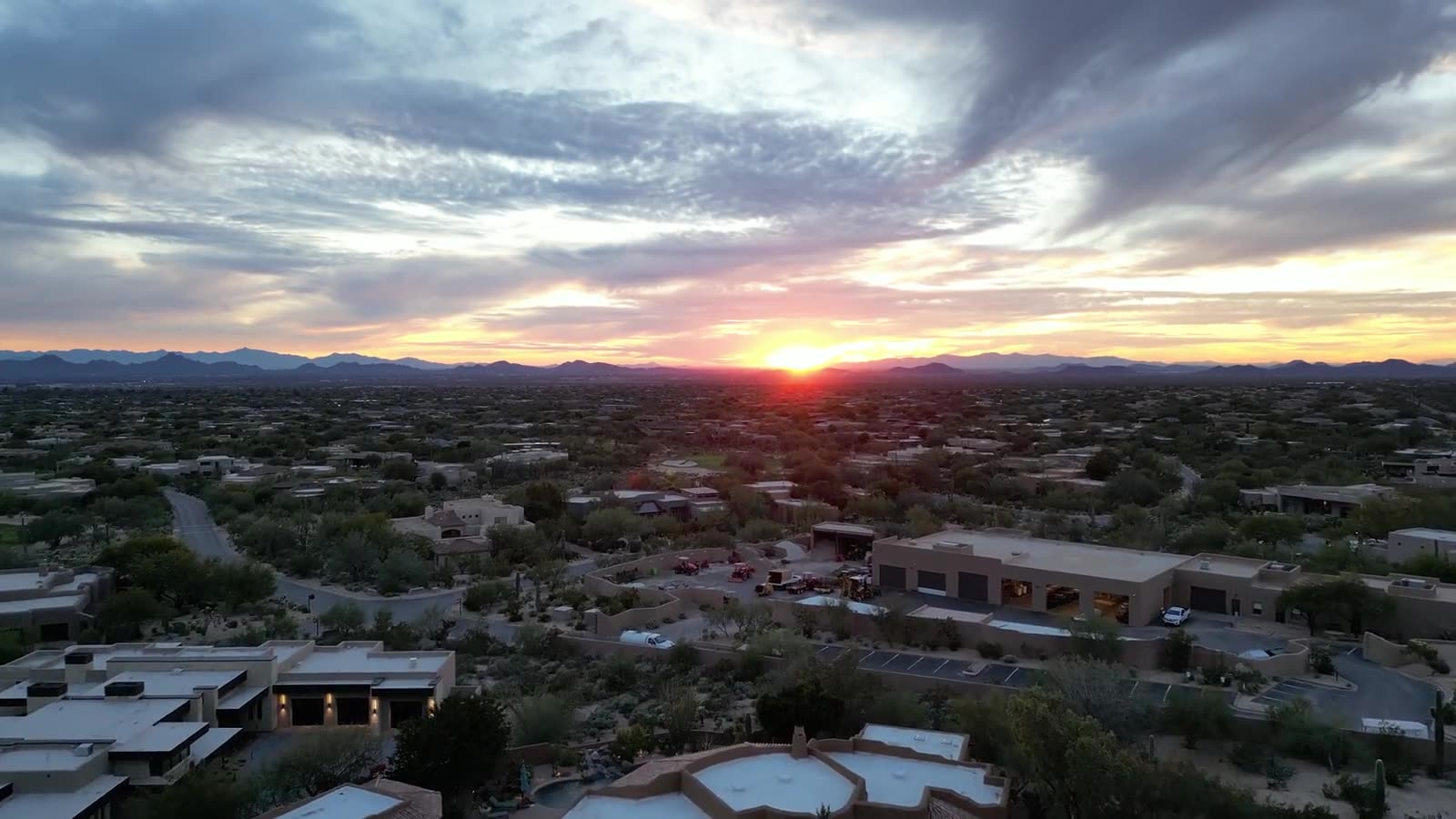 Aerial view of a Southwest desert neighborhood at sunset